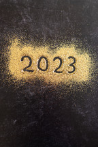 Gold glitter with the year 2023 written in it