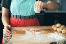 a woman in the kitchen baking cookies 