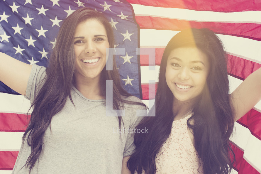 friendship between young women under an American Flag