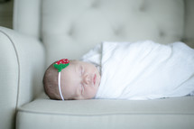 a swaddled newborn baby girl 