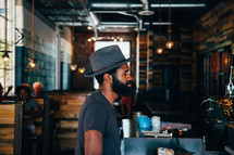 man in a restaurant in a hat 