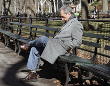 A man sitting on a park bench 