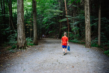boy walking on a nature trail 