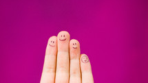 smiling faces on fingers 