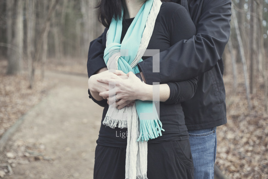 man and a woman hugging outdoors