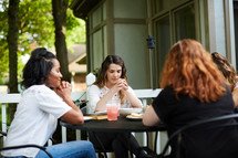 women's group Bible study around an outdoor table 