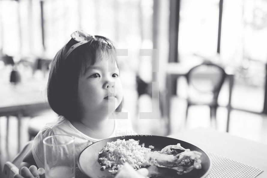 toddler girl eating dinner 