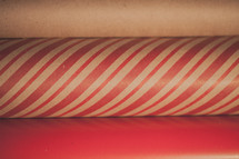 Close up of three rolls of Christmas wrapping paper