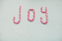 Candy canes spelling out the word, "joy."