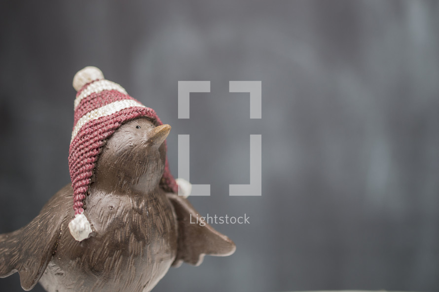 bird figurine in a winter hat 