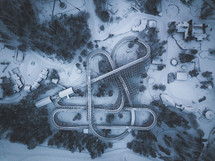 aerial view over a roller coaster covered in snow 