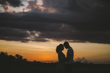 a couple embracing at dusk 