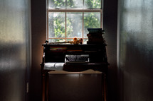 a secretary desk in a window 