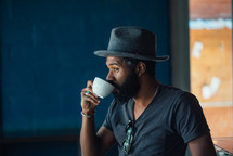 a man sipping from a coffee cup 