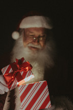 Santa opening a magical gift 