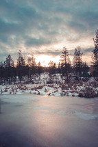 frozen pond at sunset 