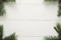 pine garland border on white wood. 