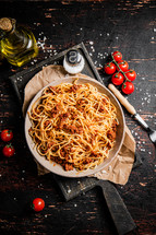 Homemade spaghetti bolognese in a plate on the table. Against a dark background. High quality photo