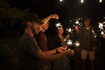 people holding sparklers 