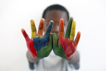 a little boy with painted hands 