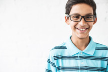 smiling boy child wearing reading glasses 