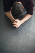 man on the ground in prayer 