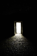 light in a doorway shining into a dark room 