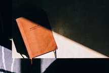 a journal in sunlight on a table 