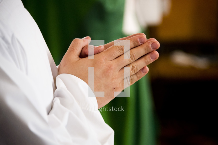 praying hands of a priest 
