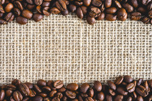 A frame of Coffee beans, on Burlap fabric. Background voor coffee related products.
