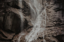 rugged misty waterfall and cliff