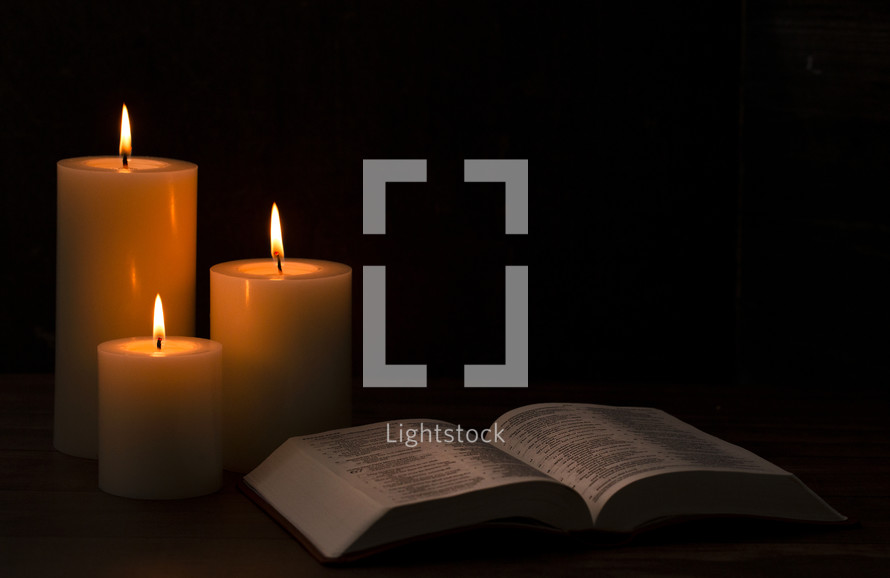 candles and opened Bible 
