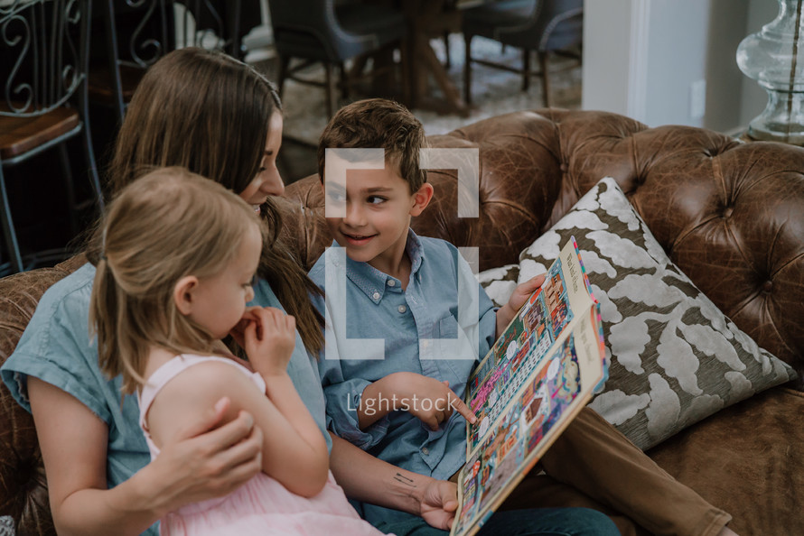 a mother reading to her children 