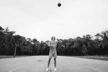 teen boy playing basketball 