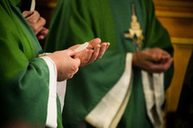 priests taking communion 