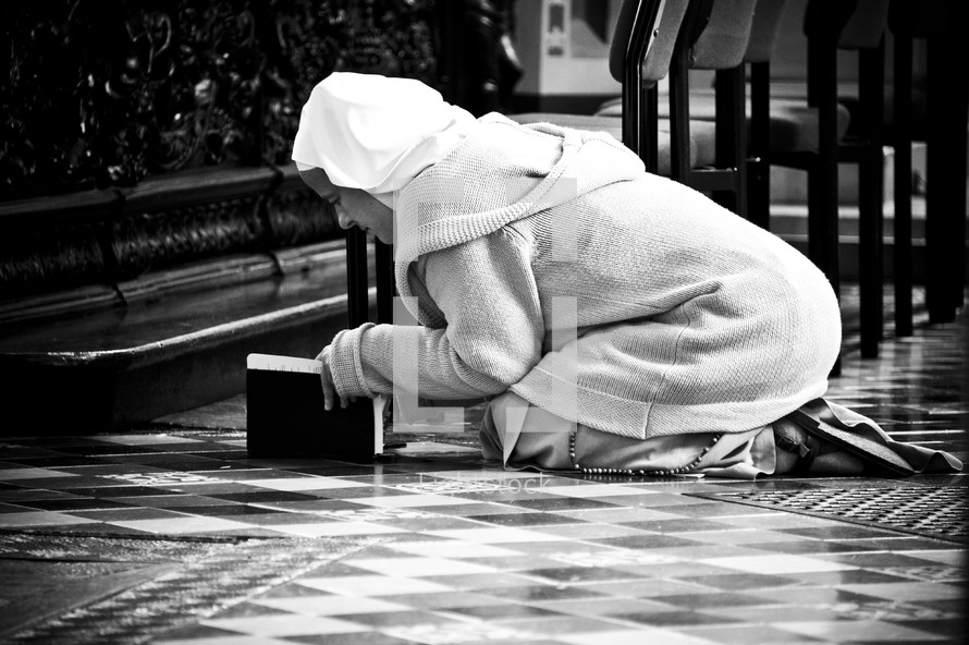 woman bowing in prayer 
