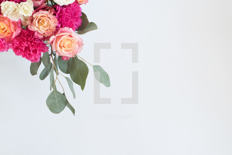 A bouquet of pink and white flowers on a white background.