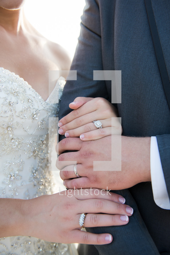 rings on the hands of a bride and groom 