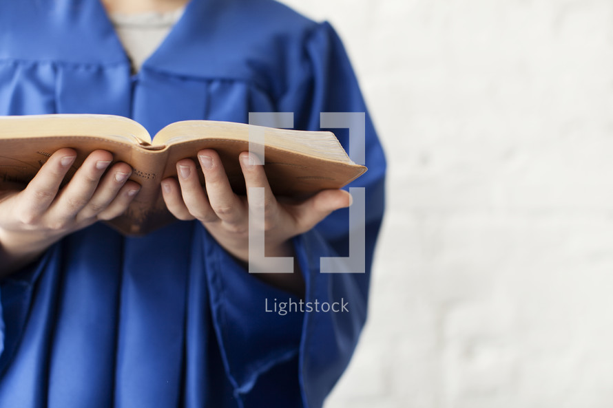 graduate holding a Bible 