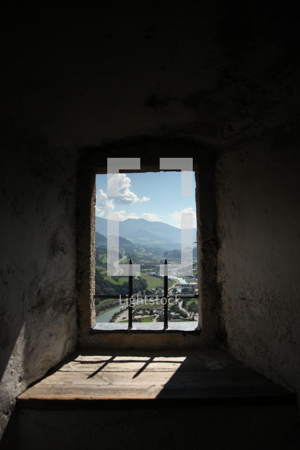 view of mountains through a window opening 