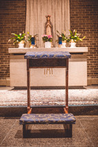 kneeling bench in front of an altar 