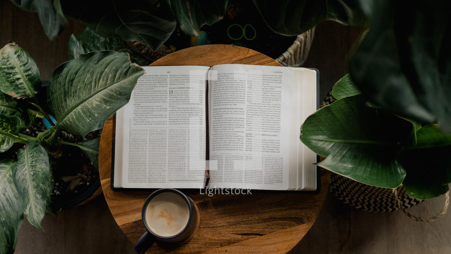 coffee mug and opened Bible on a wood table 