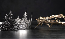 crown and crown of thorns on a wooden background 