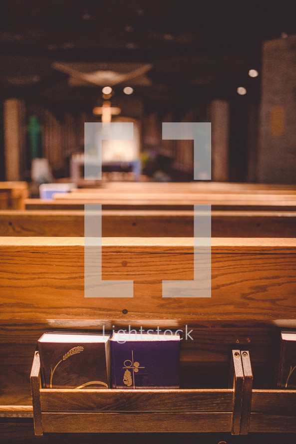 hymnals and books of worship in pews 