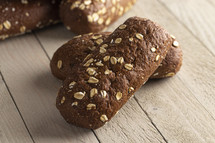 Dark Brown Bread with Oats on a Wooden Table