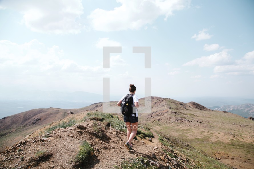 woman backpacking on a mountaintop