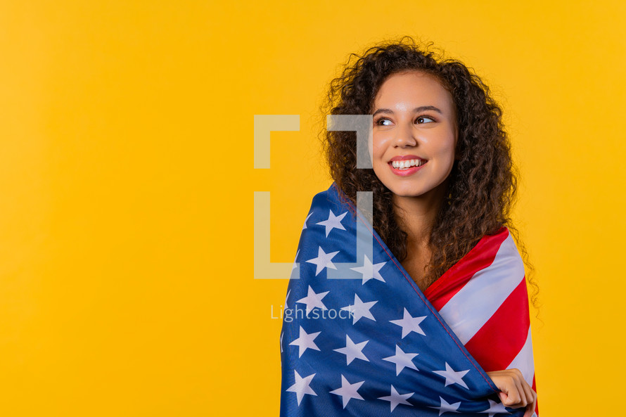 Happy woman with national USA flag on yellow background. American patriot, 4th of July - Independence day celebration, election, America, labor. US banner. High quality photo