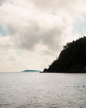 The silhouette of a tree-covered island