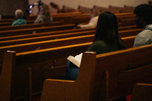 parishioners sitting in church pews 