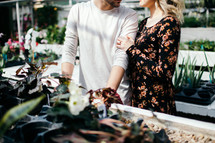 a couple in a greenhouse 